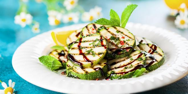 a plate of grilled zucchini drizzled in balsamic