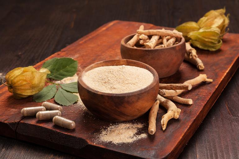 a tray with ashwagandha root, powder, and supplements